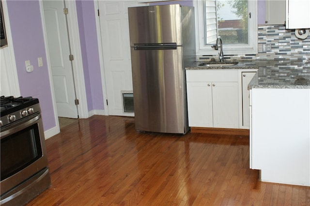 kitchen with white cabinetry, appliances with stainless steel finishes, dark wood-type flooring, and sink