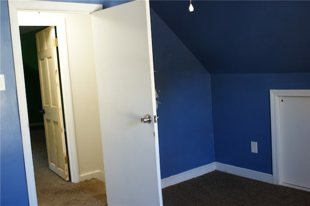 bonus room with lofted ceiling and carpet floors