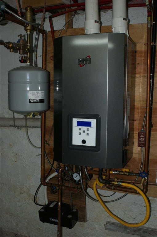 utility room featuring tankless water heater