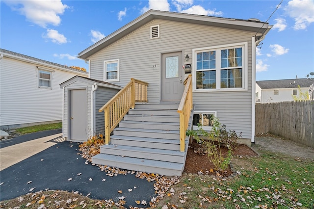 view of front of house featuring a shed