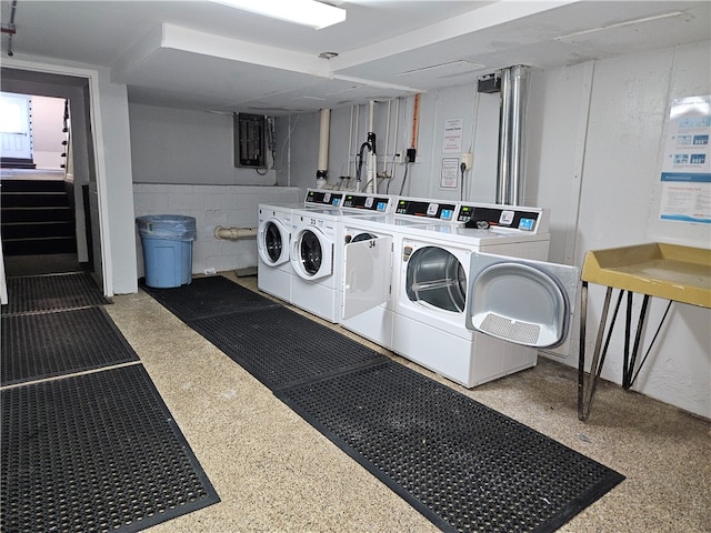 clothes washing area with washer and clothes dryer