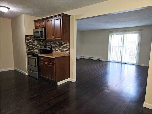 kitchen with backsplash, dark hardwood / wood-style floors, baseboard heating, appliances with stainless steel finishes, and a textured ceiling