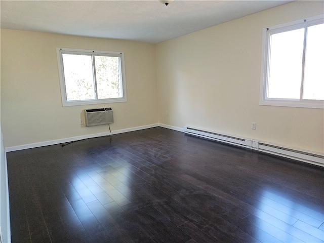 spare room with a wall mounted AC, dark hardwood / wood-style floors, and a baseboard heating unit