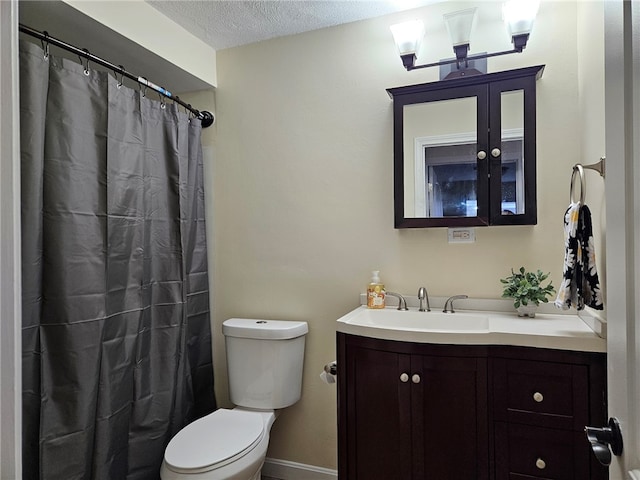 bathroom featuring vanity, a shower with curtain, a textured ceiling, and toilet