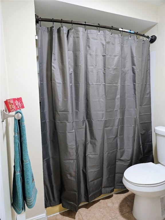 bathroom with tile patterned flooring and toilet