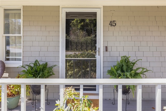 view of exterior entry featuring a balcony