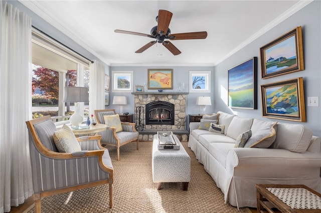 living room featuring a fireplace, ceiling fan, and crown molding