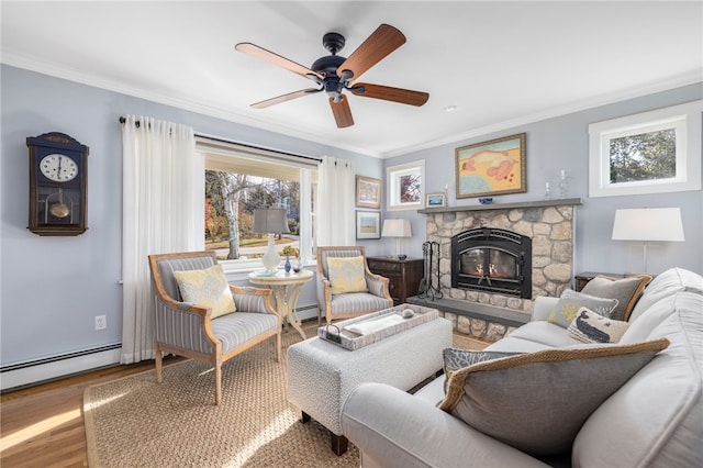 living room featuring crown molding, a stone fireplace, hardwood / wood-style floors, a baseboard radiator, and ceiling fan