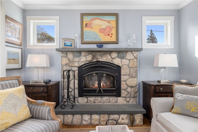 interior space featuring hardwood / wood-style flooring, a stone fireplace, and crown molding