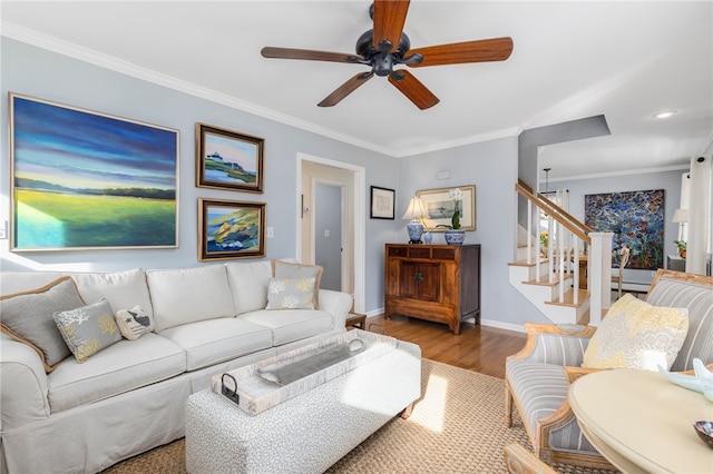 living room with hardwood / wood-style floors, ceiling fan, and ornamental molding