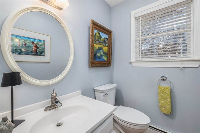 bathroom featuring toilet, sink, and a baseboard radiator