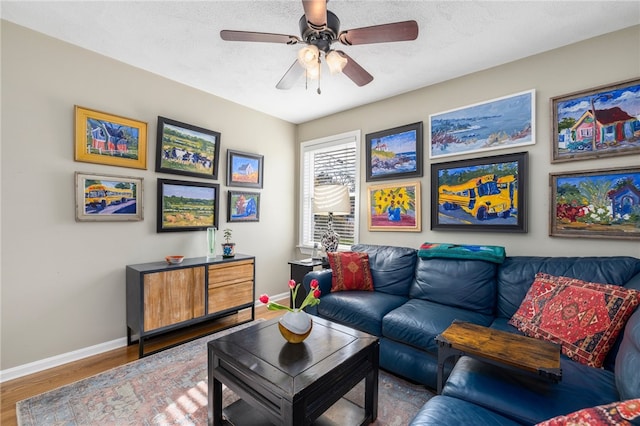 living room featuring a textured ceiling, hardwood / wood-style floors, and ceiling fan