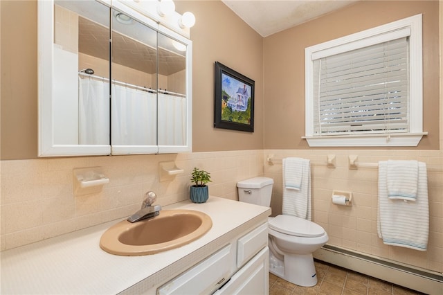 bathroom with a baseboard heating unit, toilet, tile walls, tile patterned flooring, and vanity