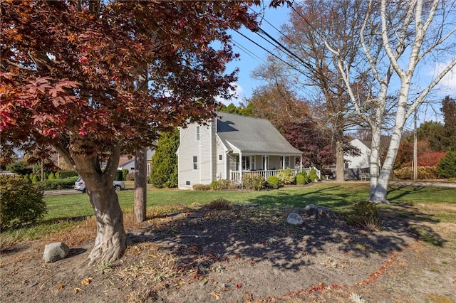 view of property exterior with a porch and a yard