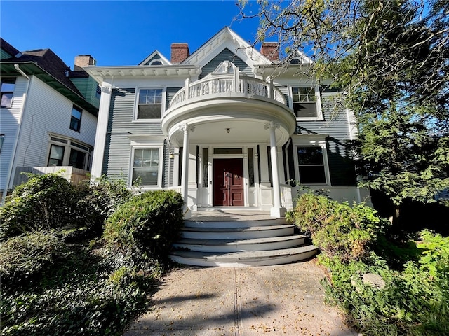 view of front of home with a balcony