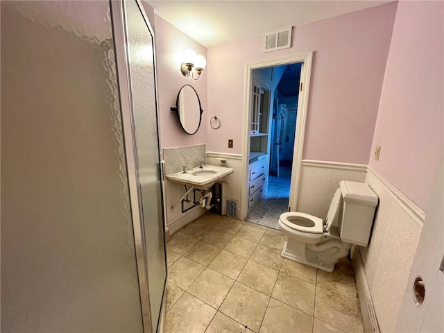 bathroom with tile patterned floors and toilet