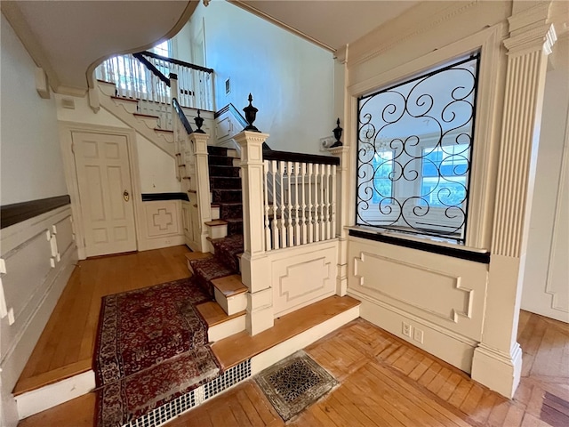 foyer with light hardwood / wood-style flooring and crown molding