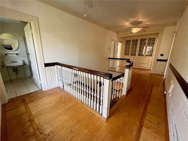 hallway featuring hardwood / wood-style flooring and crown molding