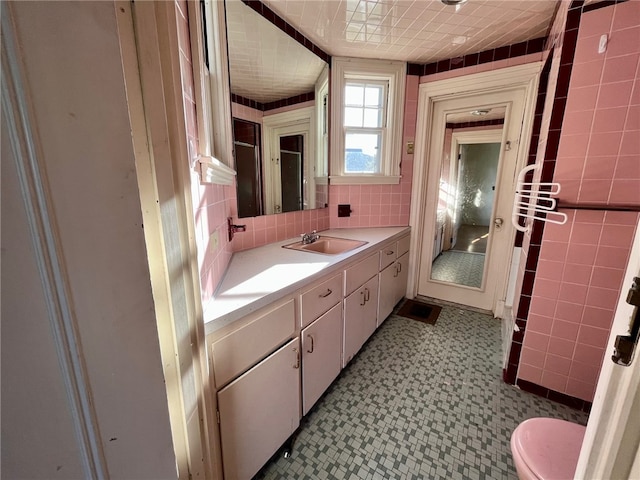 bathroom featuring tile walls and vanity