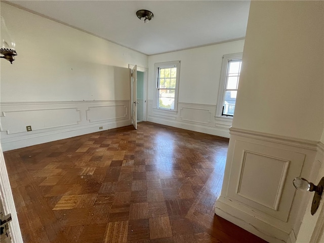 spare room featuring dark parquet flooring