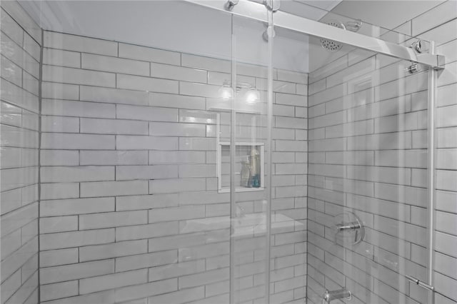 bathroom with a shower with shower door