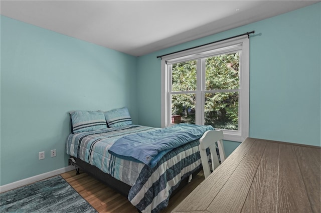 bedroom featuring hardwood / wood-style floors and multiple windows