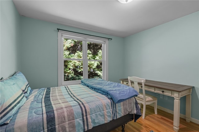 bedroom with hardwood / wood-style floors