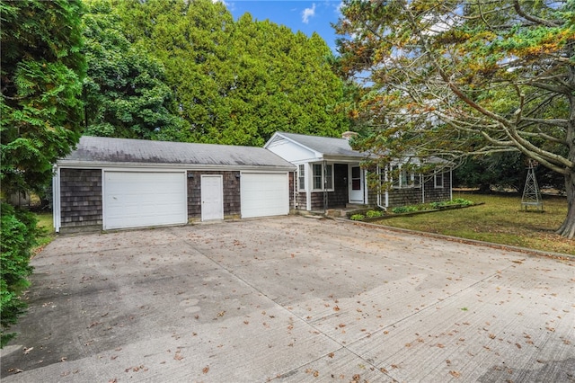 view of front of property with a garage, a porch, and a front lawn