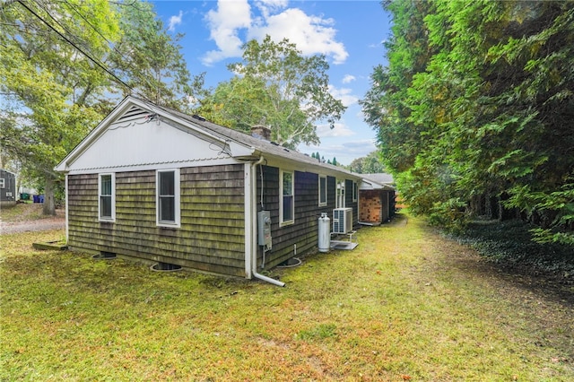 view of side of property with a yard