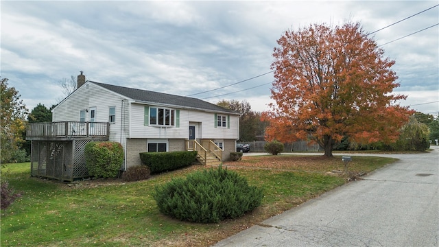 view of front of house with a front lawn and a deck