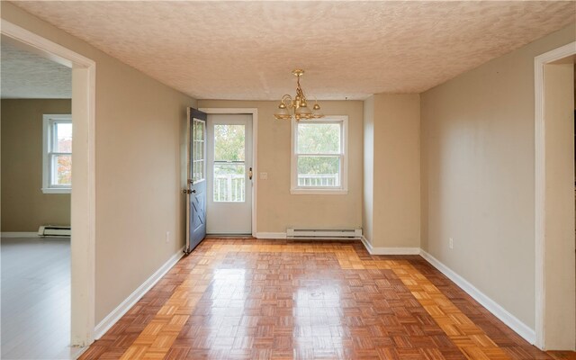 entryway with light parquet floors, a chandelier, a baseboard radiator, and a textured ceiling