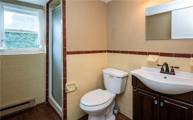 bathroom featuring a baseboard heating unit, tile walls, wood-type flooring, and vanity