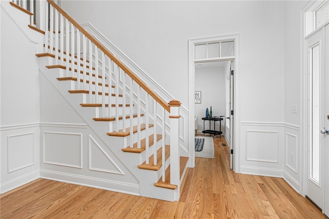 staircase with hardwood / wood-style floors