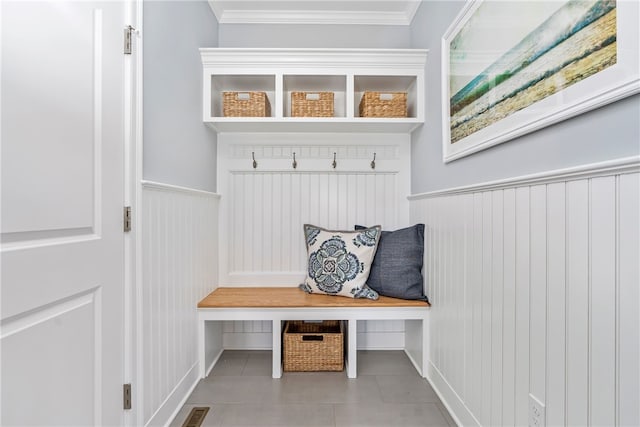 mudroom featuring light tile patterned floors and ornamental molding