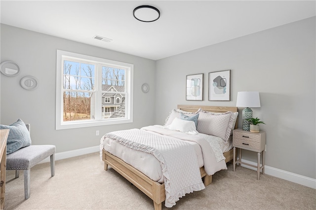 bedroom featuring light carpet