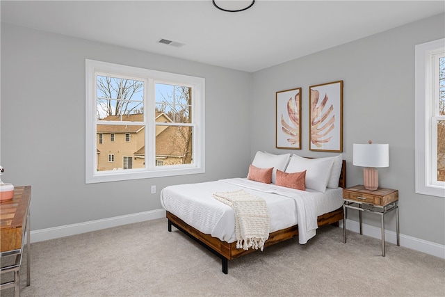 bedroom featuring light carpet