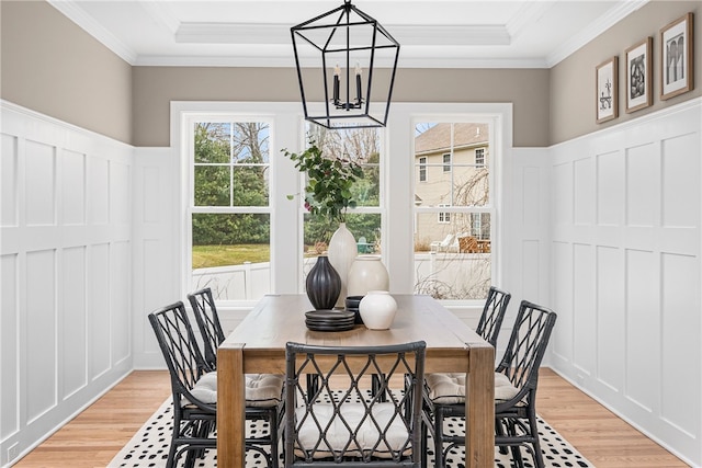 dining room featuring plenty of natural light, light wood-type flooring, and ornamental molding