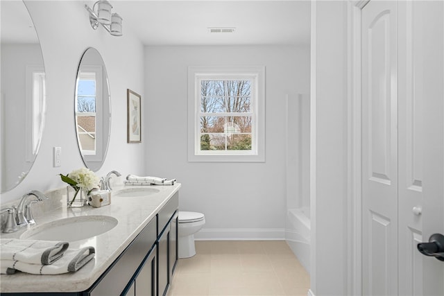 bathroom with toilet, vanity, tile patterned floors, and a bathing tub