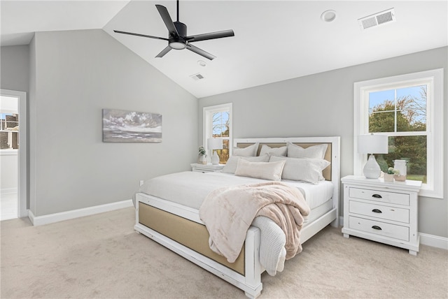 bedroom with ceiling fan, light carpet, and vaulted ceiling