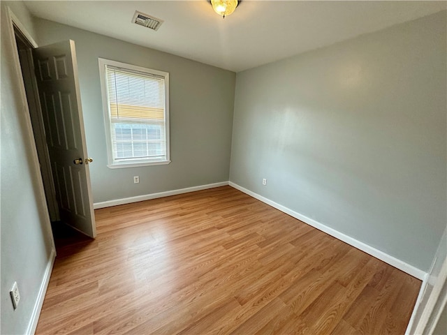 spare room with light hardwood / wood-style flooring