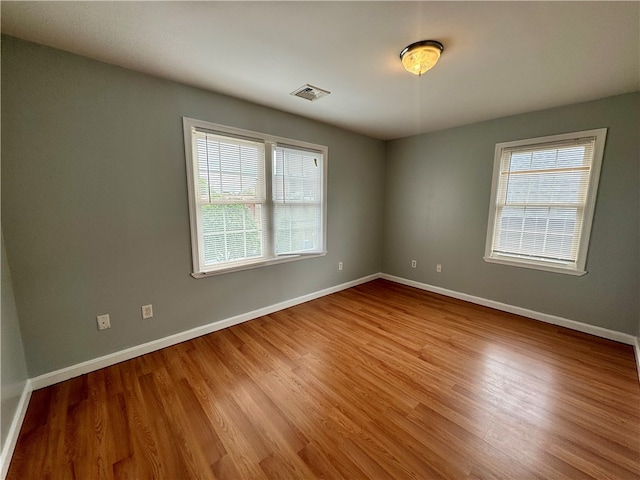 empty room with light hardwood / wood-style floors