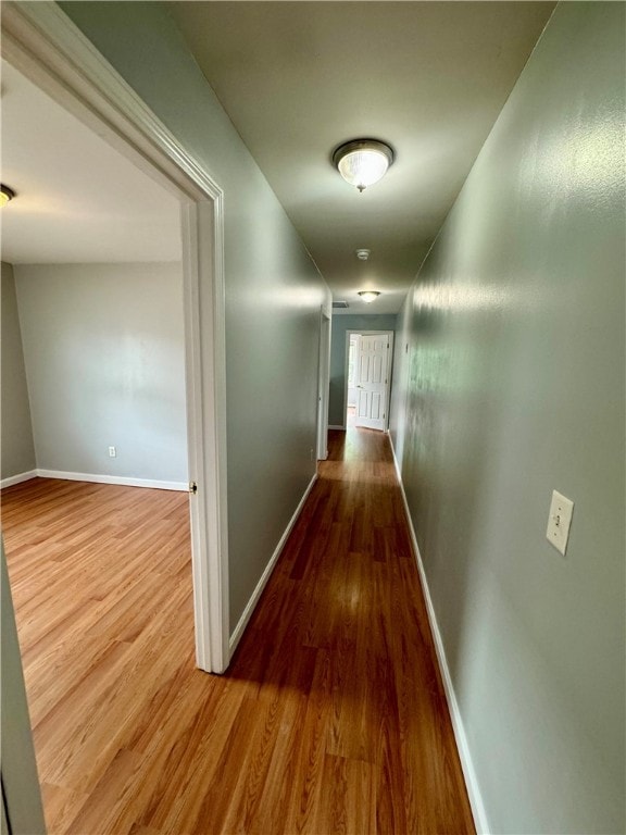 hall with wood-type flooring