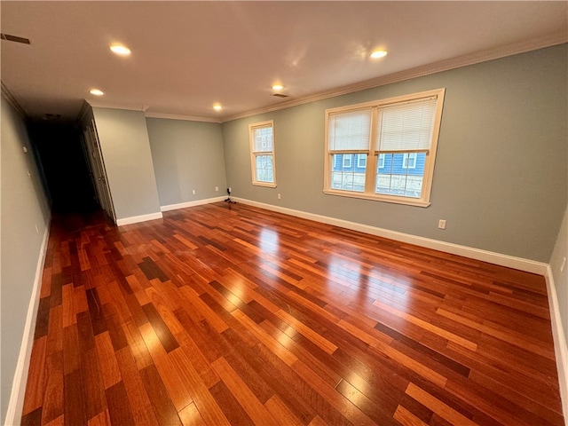 empty room with wood-type flooring and ornamental molding