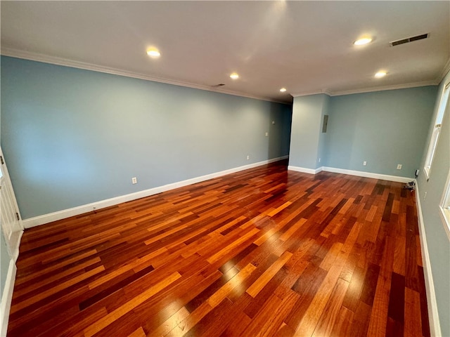 unfurnished room featuring wood-type flooring and crown molding