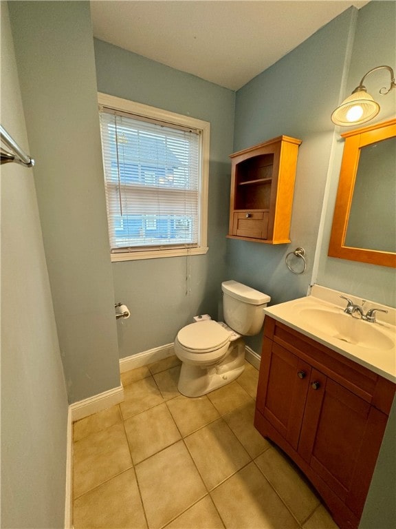 bathroom featuring tile patterned floors, vanity, and toilet