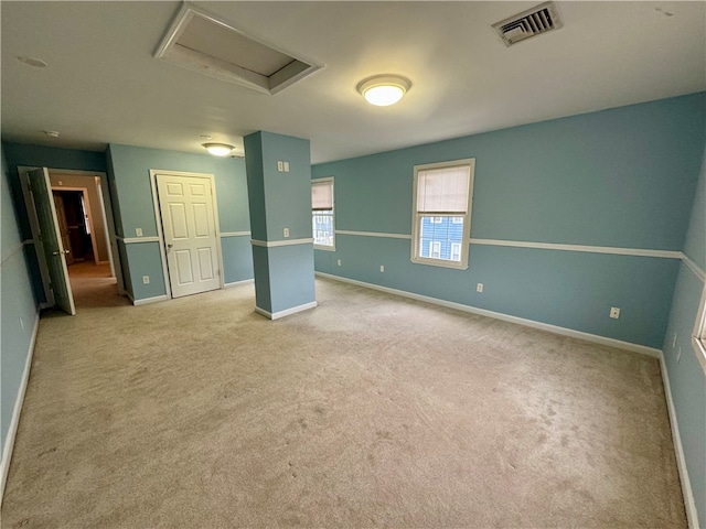 unfurnished room featuring light colored carpet