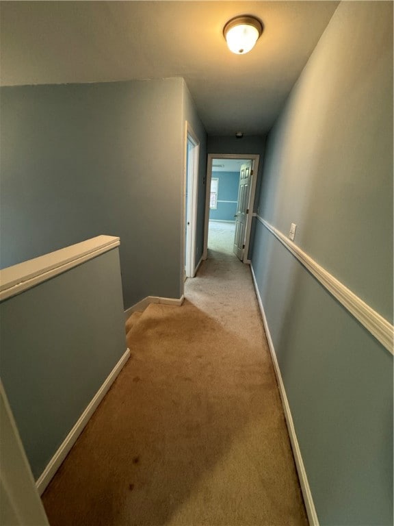 hallway with light colored carpet