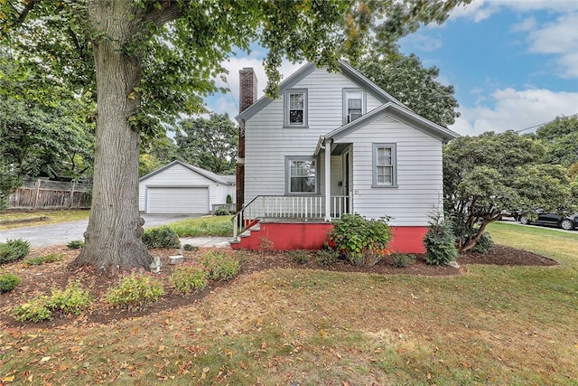 front of property featuring a garage, an outdoor structure, and a front yard