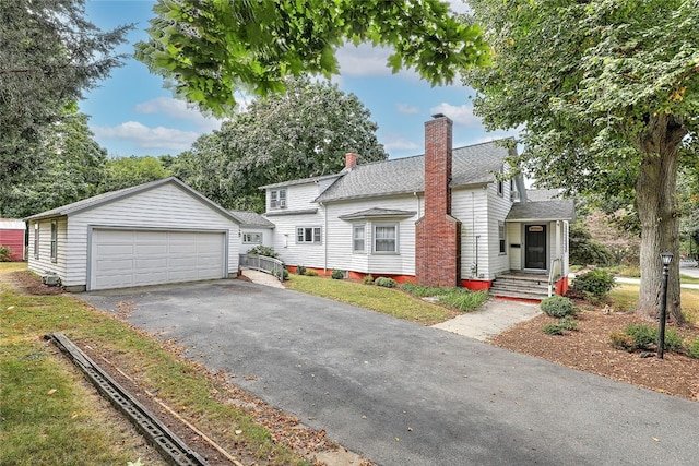 view of front of home featuring a garage and an outdoor structure