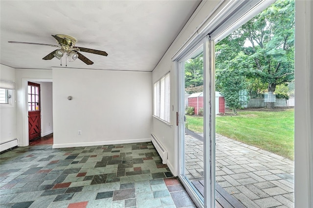 doorway with a wealth of natural light, ceiling fan, and a baseboard heating unit